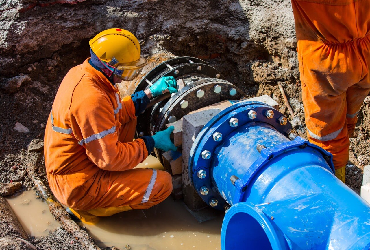 Technician working on a large pipe